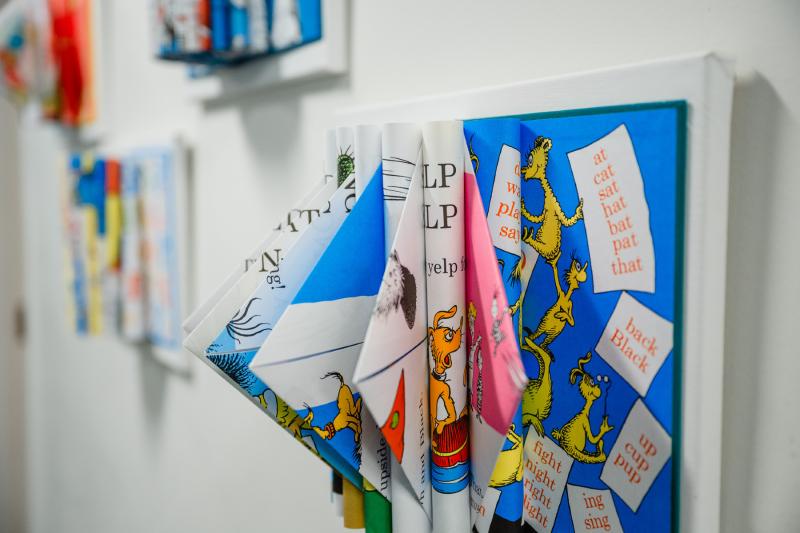 a three dimensional book on a wall with its pages folded over into triangles and coming out of the book