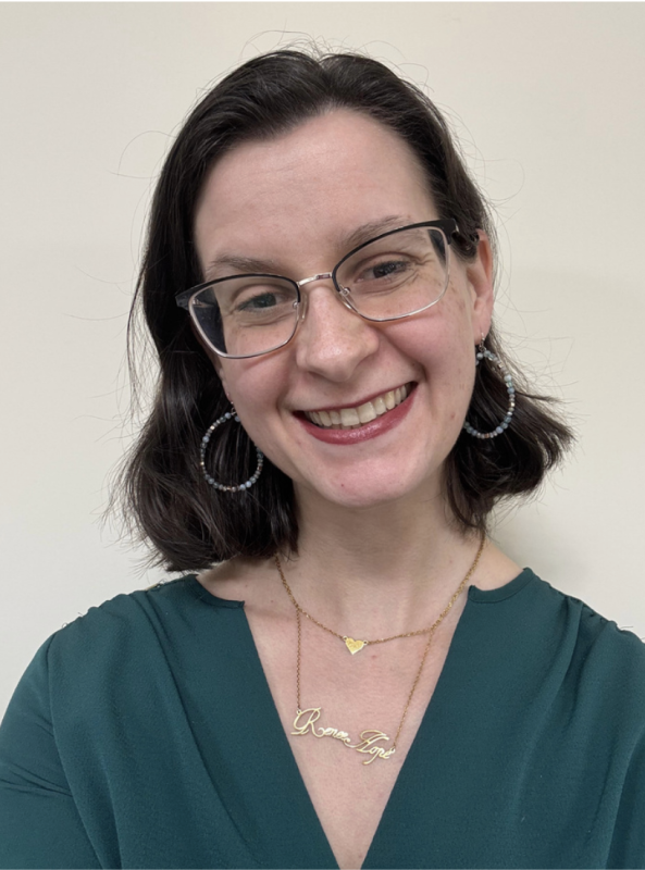 headshot of a smiling woman wearing glasses