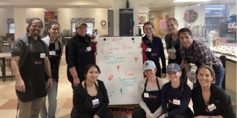 a group of medical providers in front of a white board